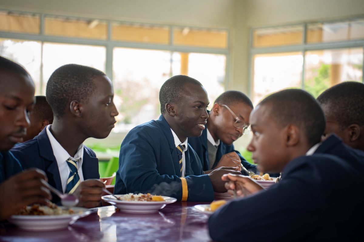 Boys talking over lunch in the dining hall