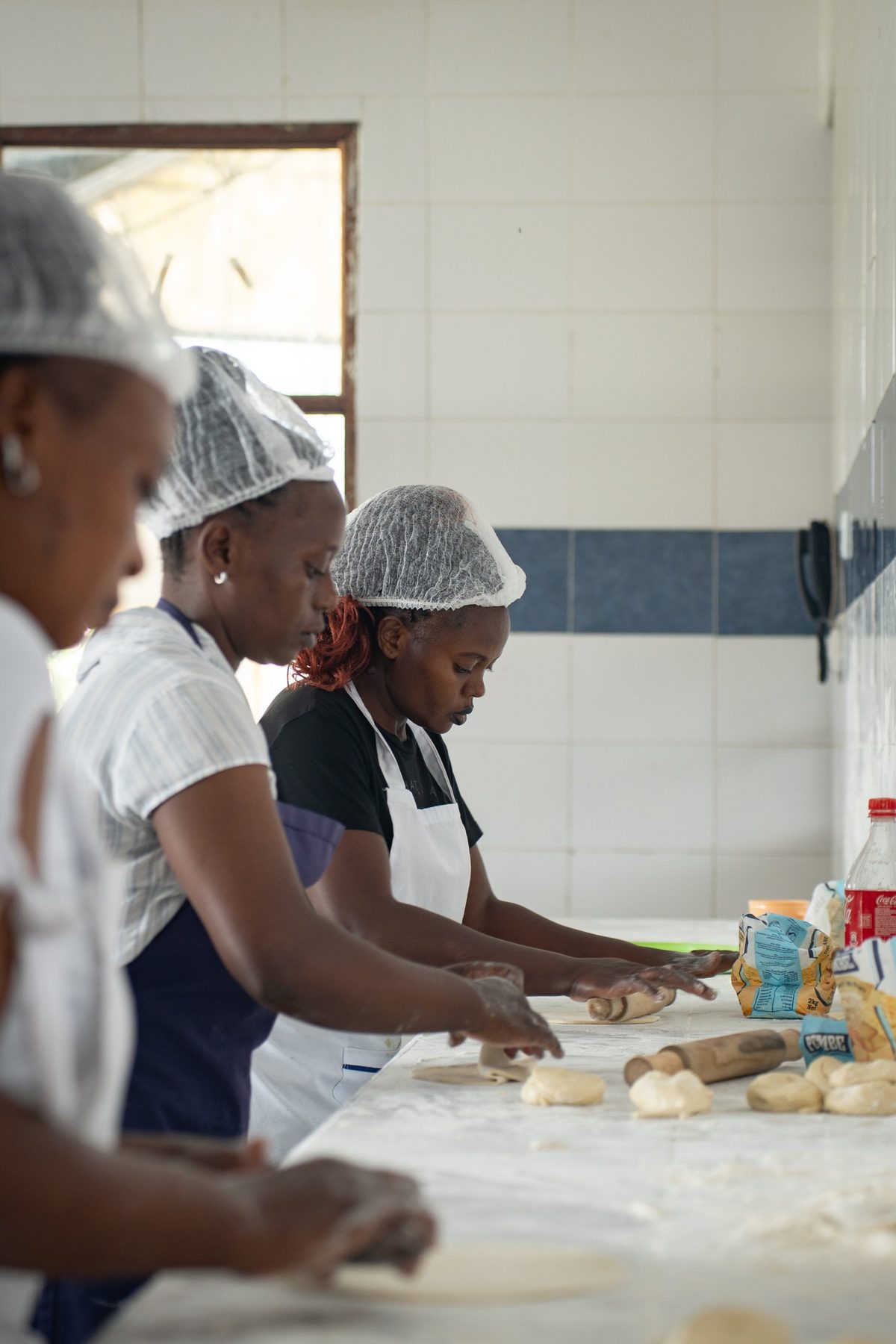 Cooks rolling chapati in the school kitchen