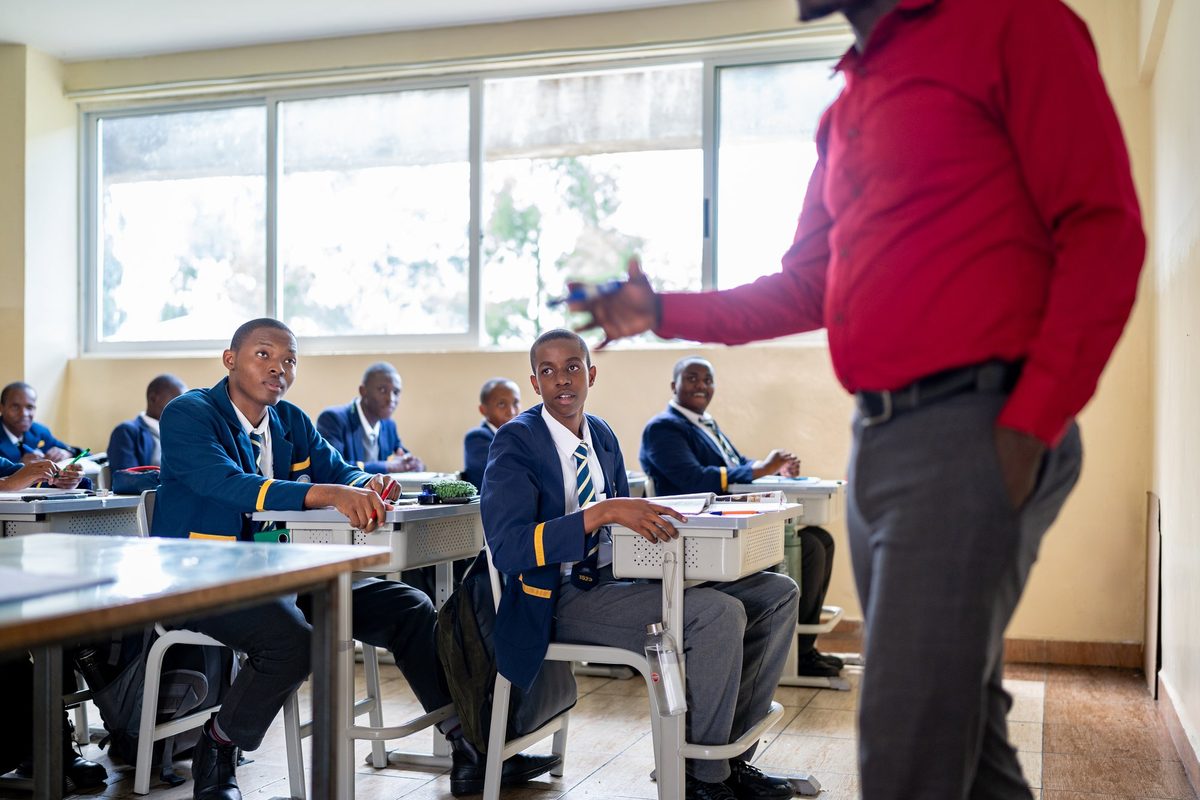 Boys in discussion with their teacher