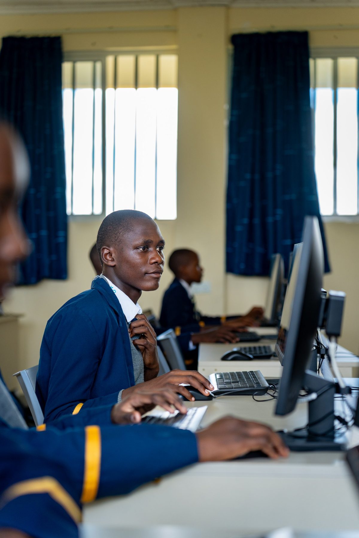 A boy working at a computer in the ICT suite
