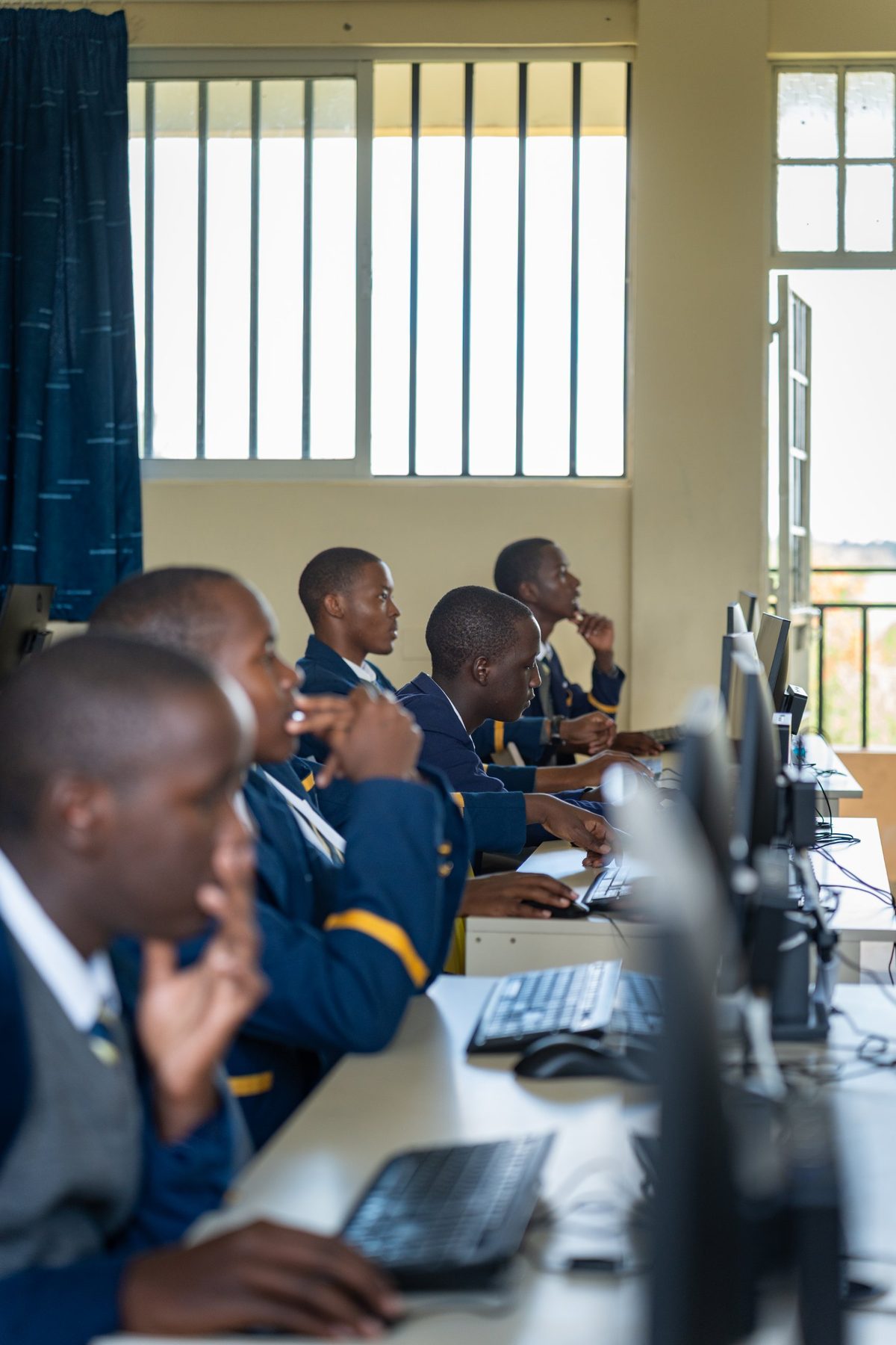 A row of boys at their computers in the ICT suite